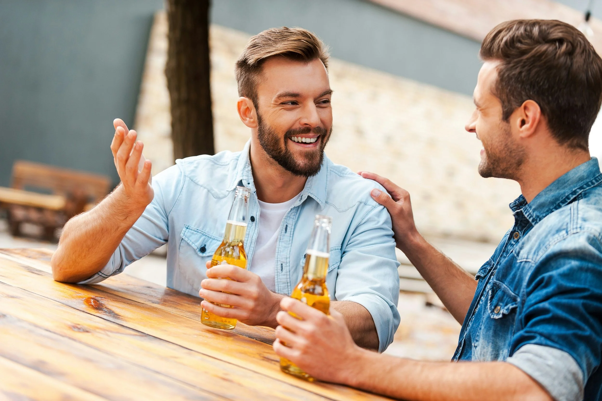 Men sharing bottled tea getty-images-P2FFXIrXRHA-unsplash.jpg