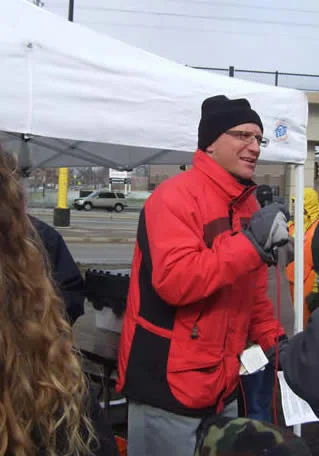 MCW Chair David Orbuch addresses the crowd under gray skies.