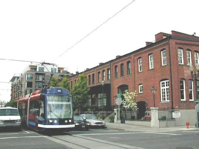 Portland Streetcar operating in mixed traffic, alongside flourishing TOD. Photo courtesy of Light Rail Now.