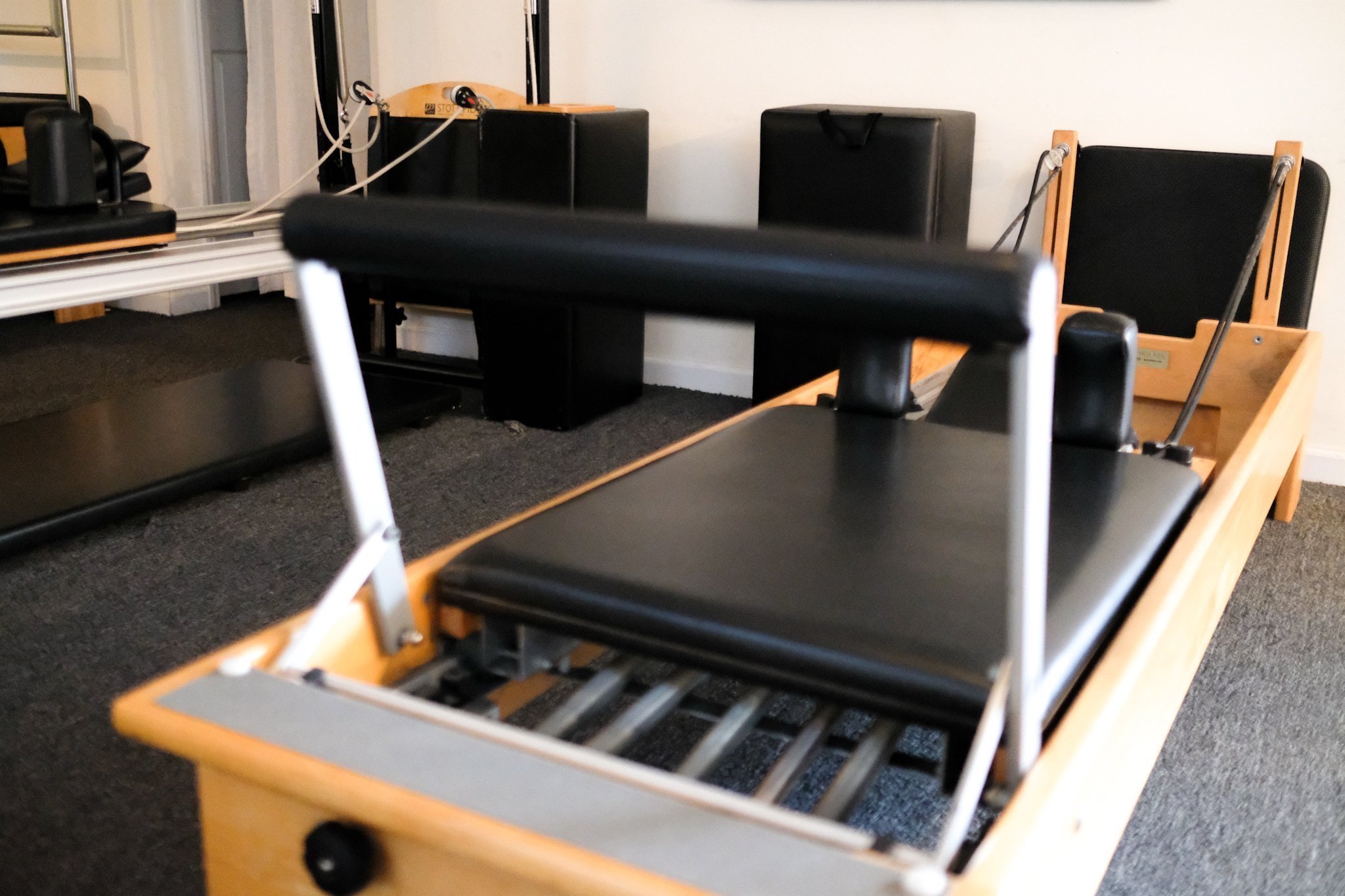  The Pilates reformer is the cornerstone of our Pilates classes. Its unique design features a sliding carriage, springs, and straps that provide resistance, helping to strengthen and tone muscles. The reformer allows for a wide range of exercises tha