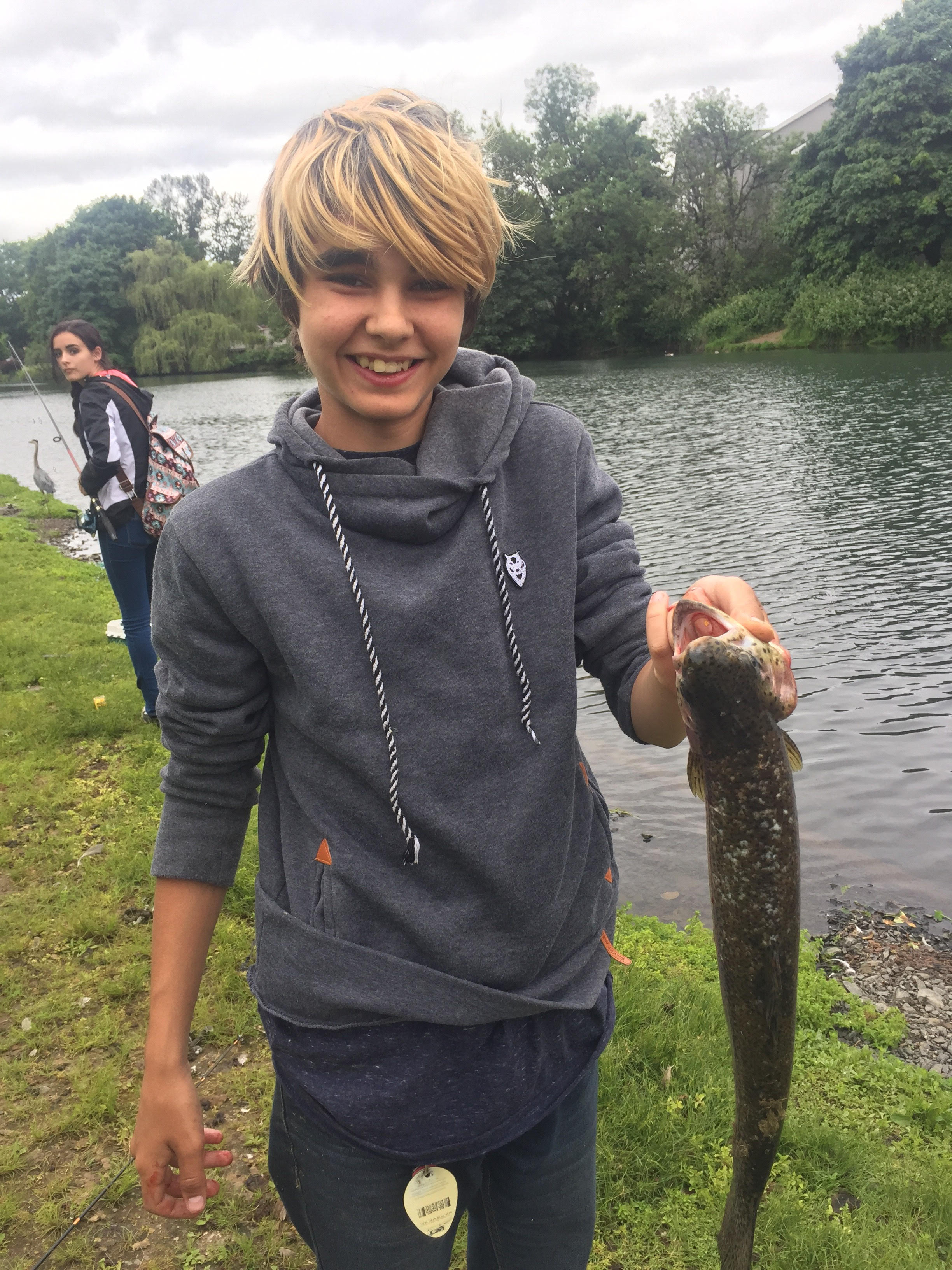 A student shows off his big catch in the Hooked! course offered through Nearby Nature.