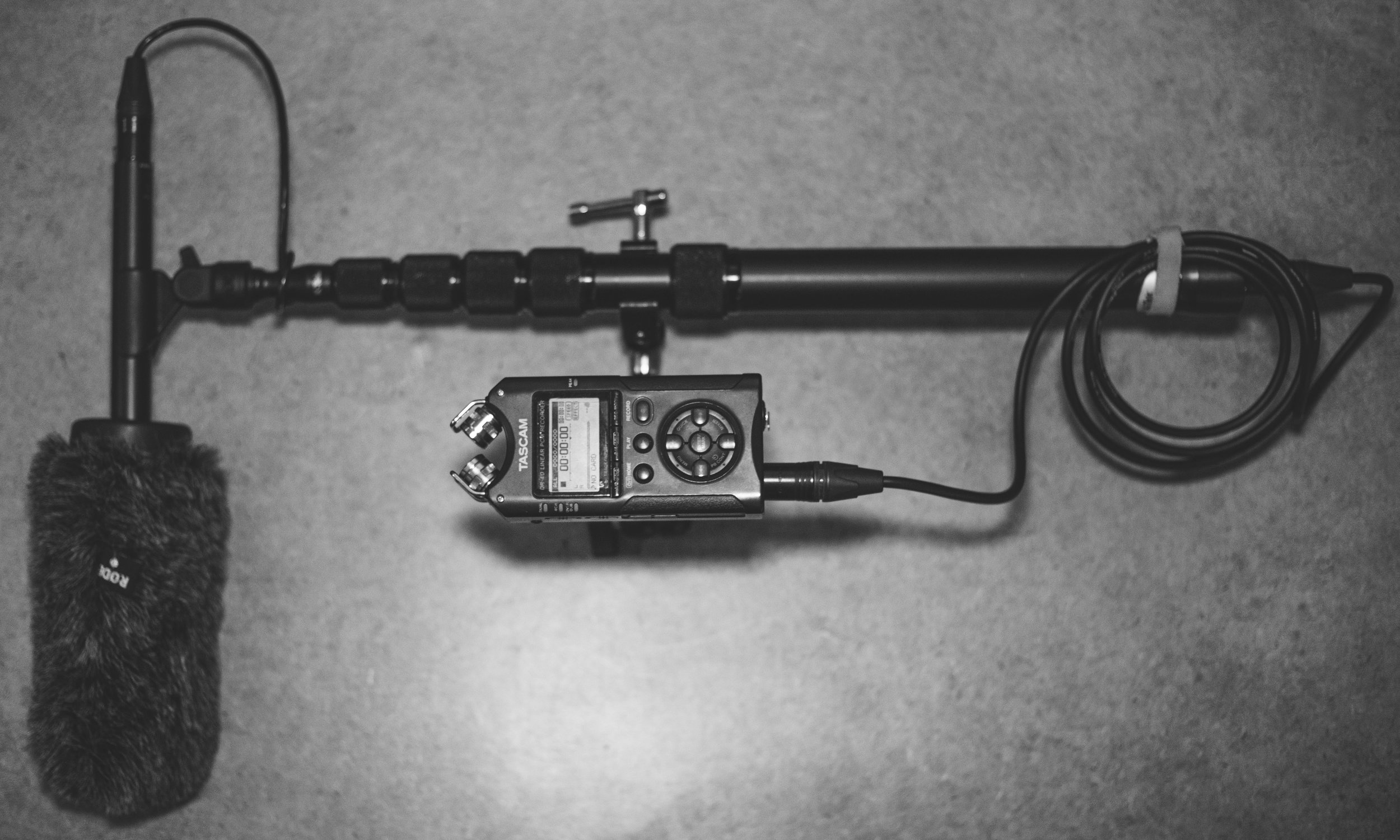Above is an NTG4+ Shotgun microphone , K-Tek Avalon Series Boom Pole , and a Tascam DR-40 attached by a GkGk Articulating Friction Magic Arm .