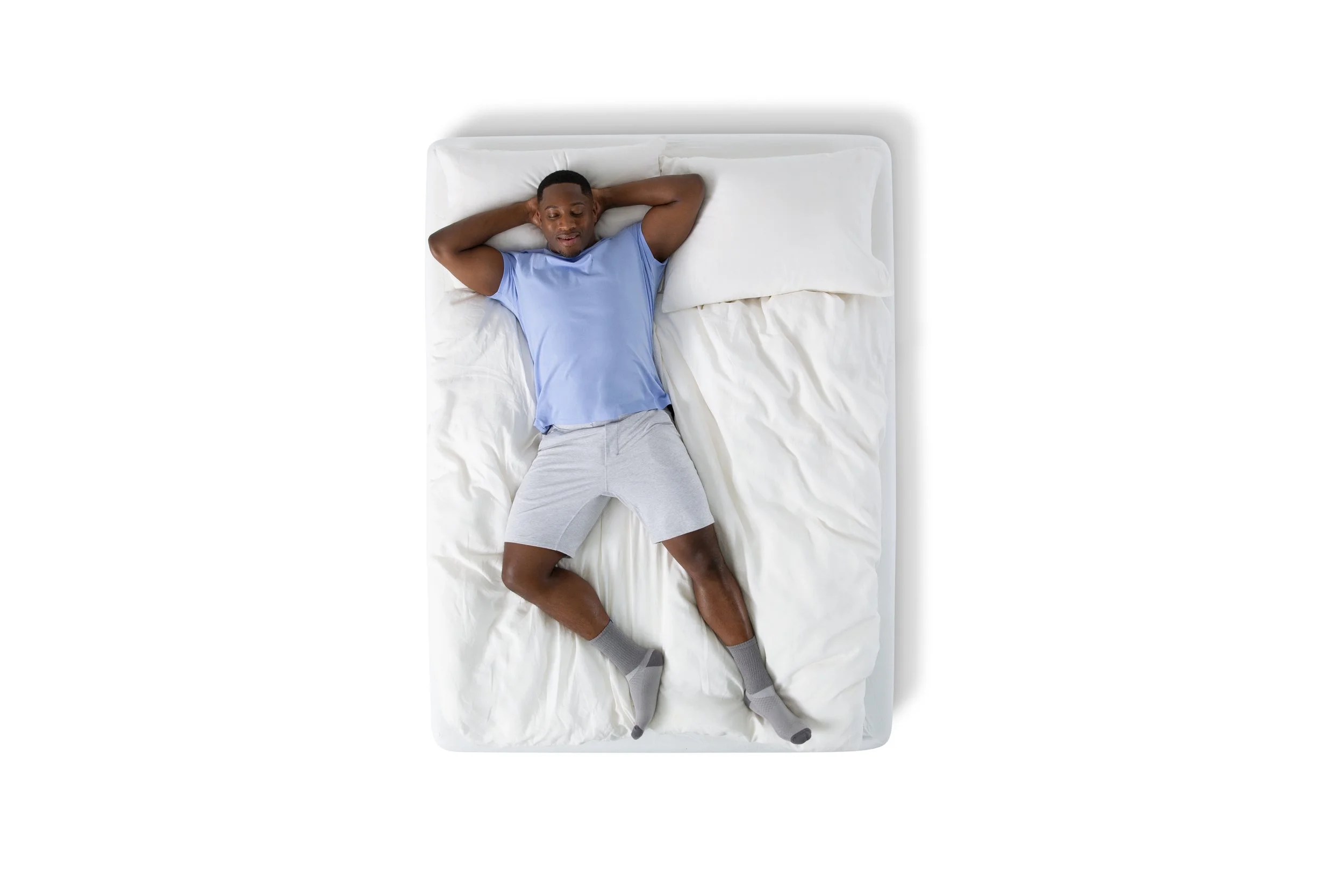 SE23_NL_PerfectSleeper_DressedBed_Lifestyle_Man_Overhead_EXP_03-01-26.jpg