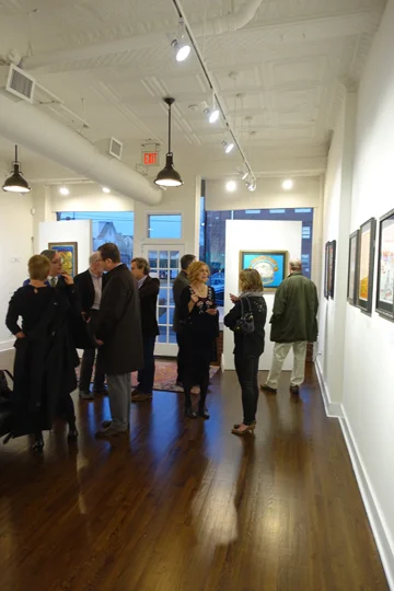 Time to mingle after the crowd checks out the posters opening night at the Bahr Gallery.