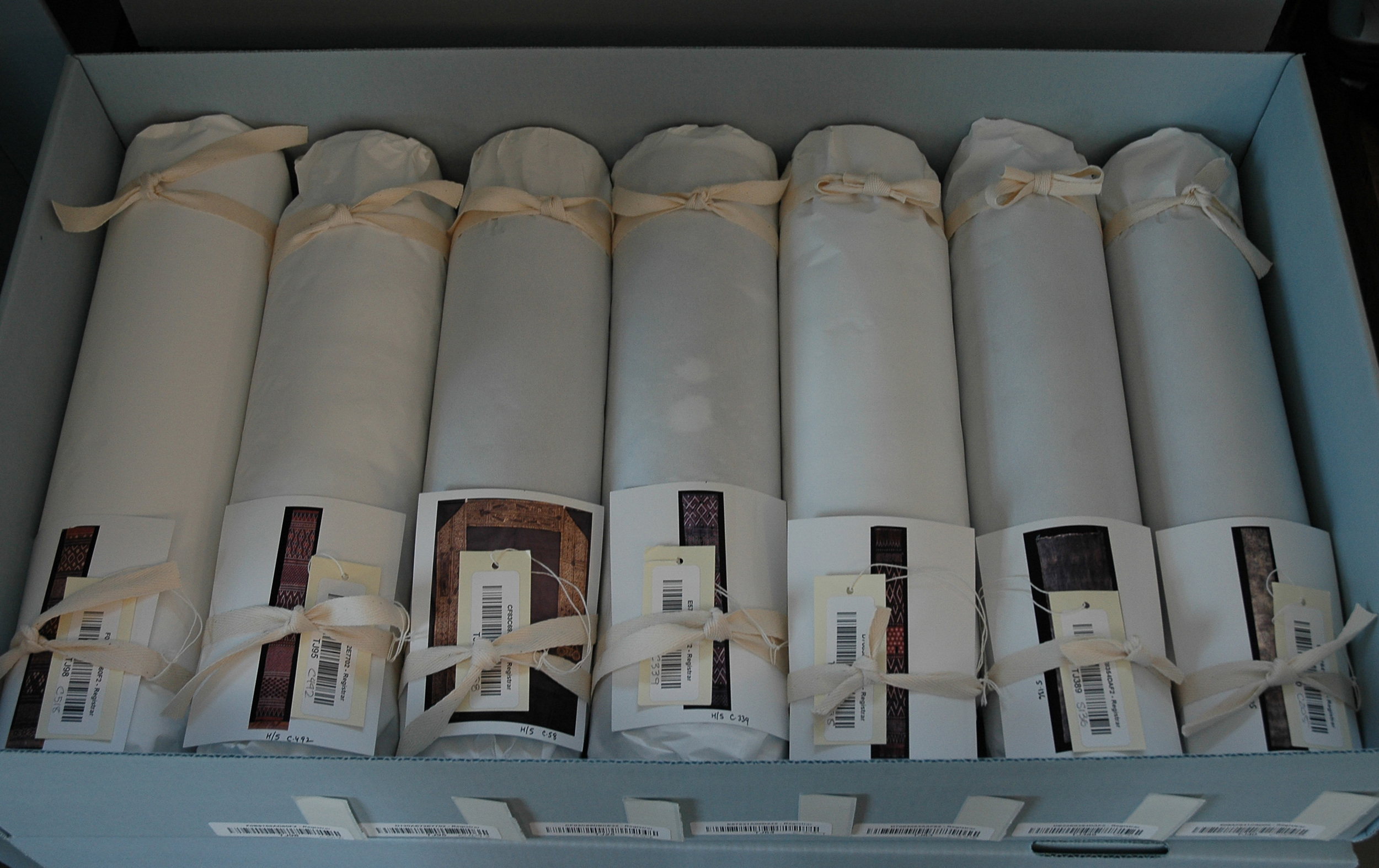 Textiles properly rolled, boxed and labeled for storage