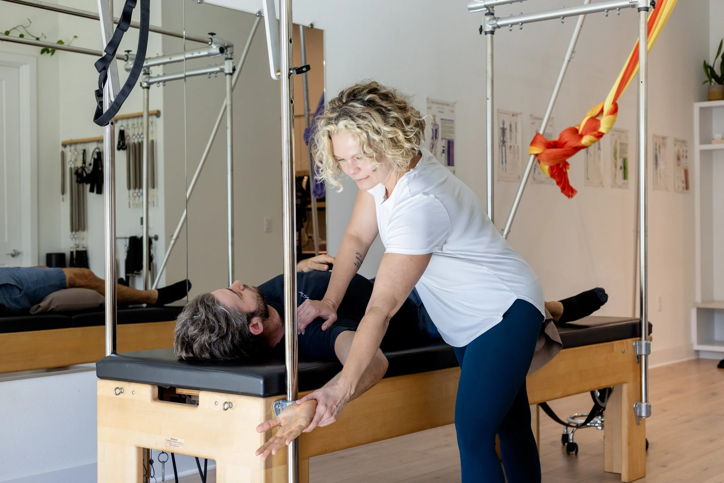 Integrating hands-on bodywork with supported movement on Pilates equipment