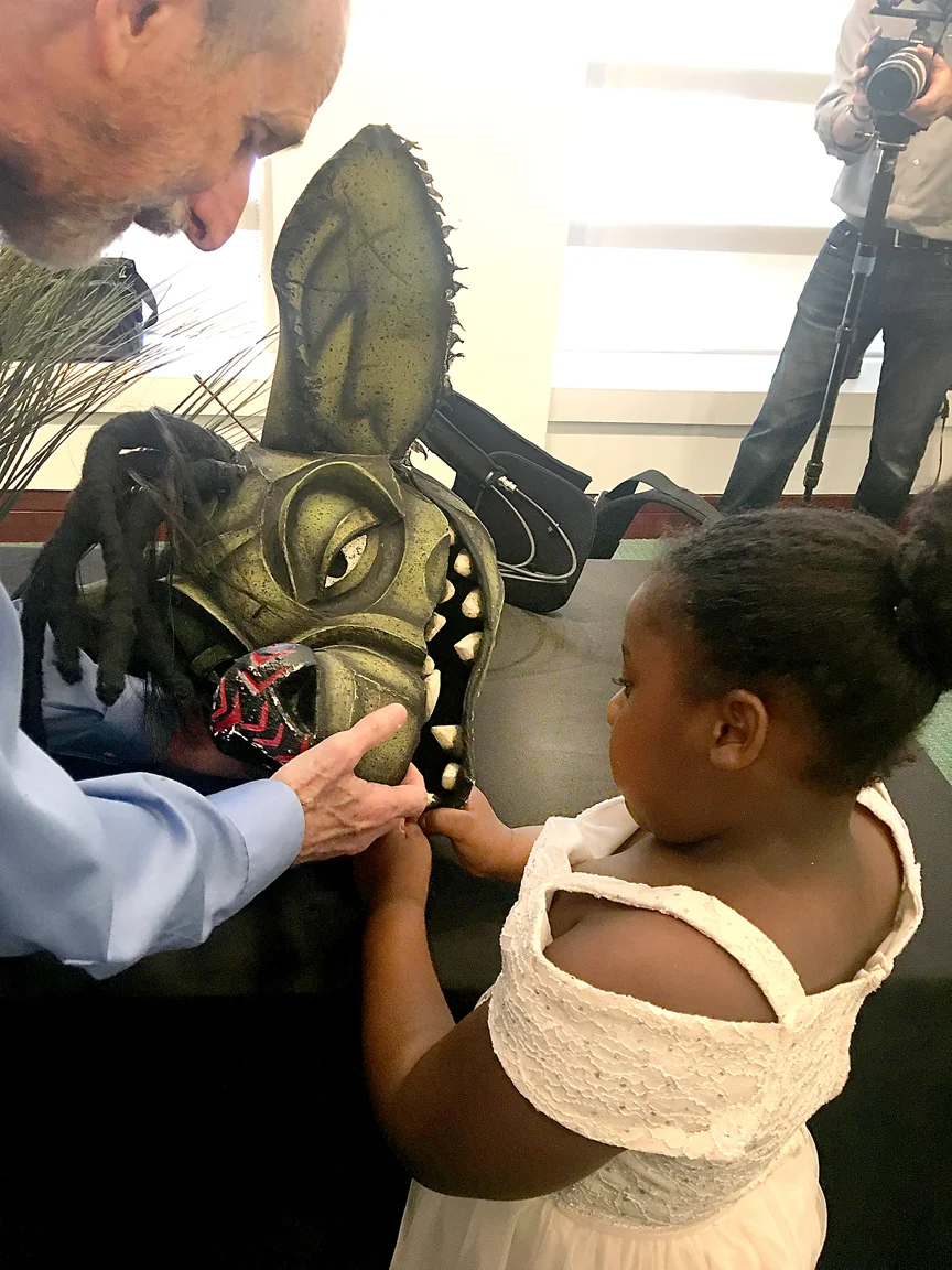 STEVE AND CHILD FEEL HYENA'S TEETH