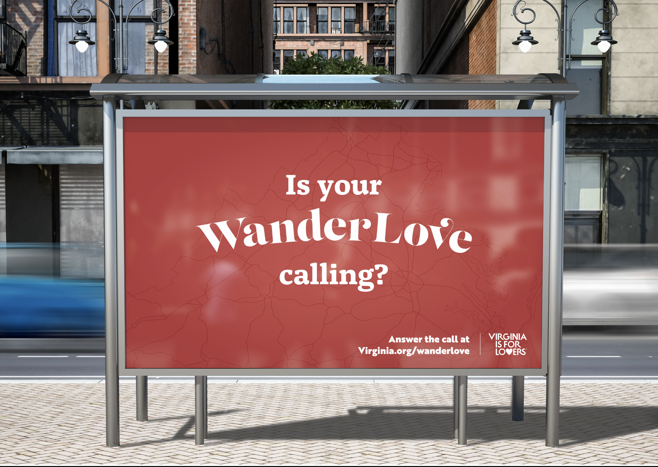 A bus shelter with a red advertisement that reads, "Is your WanderLove calling?" The background of the ad features a faint map. Below the main text, there is a call to action to answer the call at Virginia.org/wanderlove, with a small Virginia is for Lovers logo. The bus shelter is on a city street with brick buildings, fire escapes, and street lamps visible.