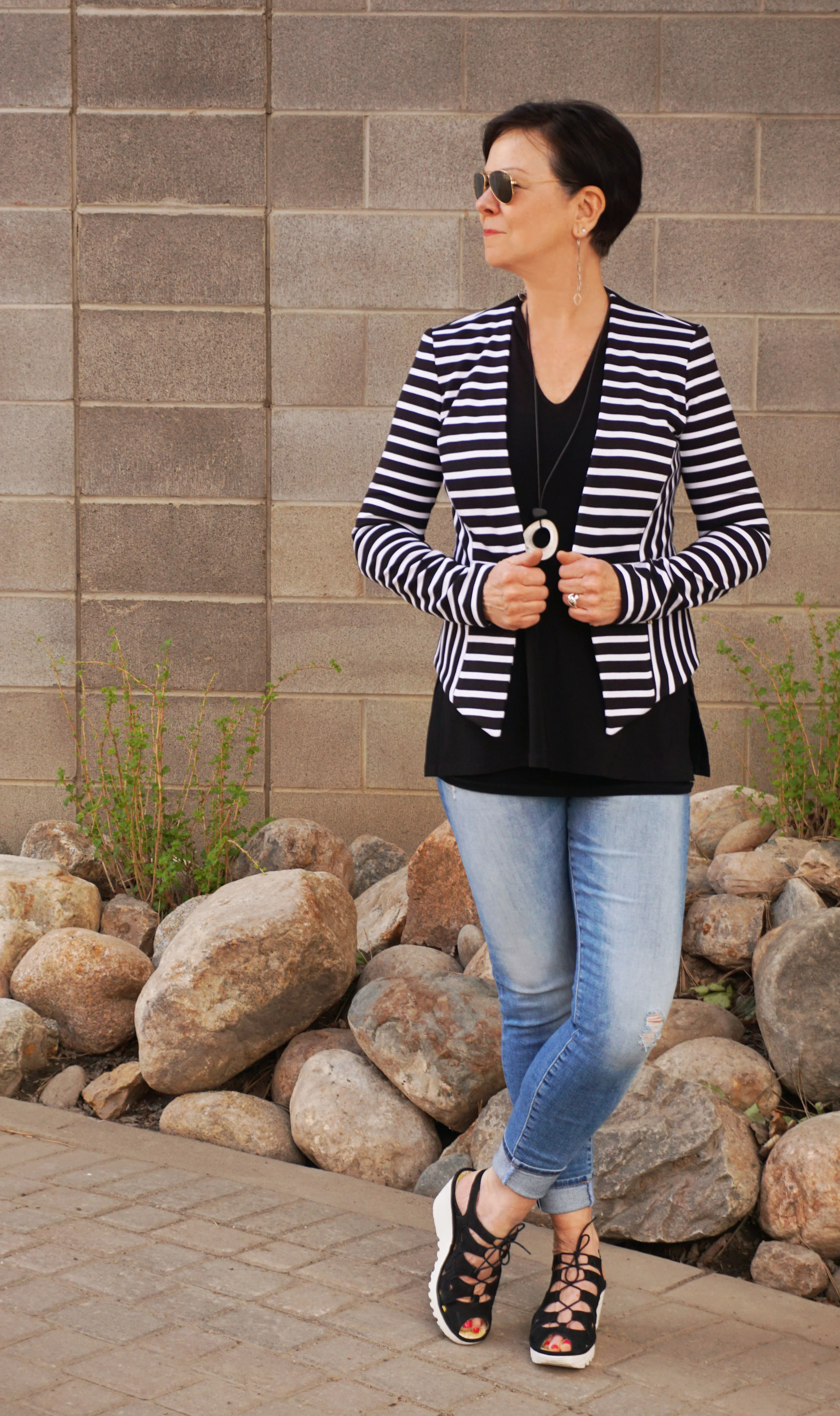 Black and white stripes are always classic and always clean and crisp for summer. Colleen loves jackets, so when she gets hot, off they come. The key is to wear a black basic underneath that doesn't cling, like this tank from Sympli. Black shoes with white soles, like these from Fly London, are so fresh and trendy.