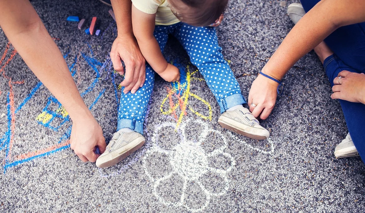 Drawing on Sidewalk with Kid and Parents by Storyblocks.jpg