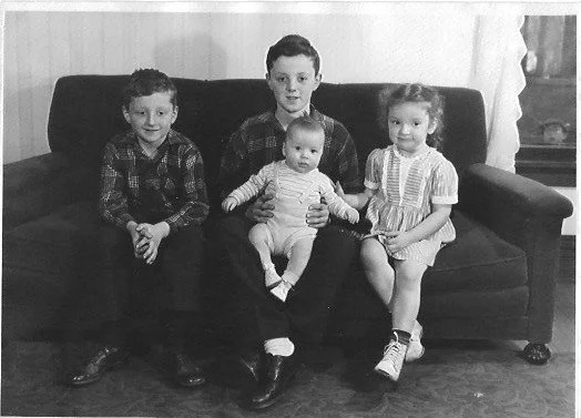 The four Hoden siblings, left to right: Tome, Mike holding Charles, and Mary. 