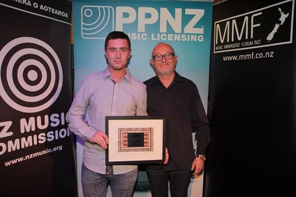 Ashton Henty (CRS Management) accepting Manager of the Year award on behalf of Paul McKesser and Campbell Smith (CRS Management) with presenter Dave Dobbyn