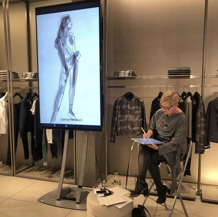 Jacqueline sketching at a live event at The Mailbox, Birmingham. iPad Pro connected to 2 metre monitor for Emporio Armani. Art work was printed on location and presented to each customer in a frame