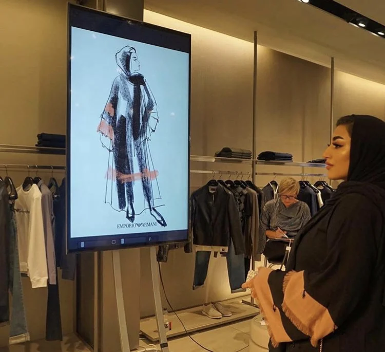 Jacqueline sketching a guest at The Mailbox, Birmingham. An evening event for Emporio Armani. Guests were presented with their printed fashion portraits in frames.