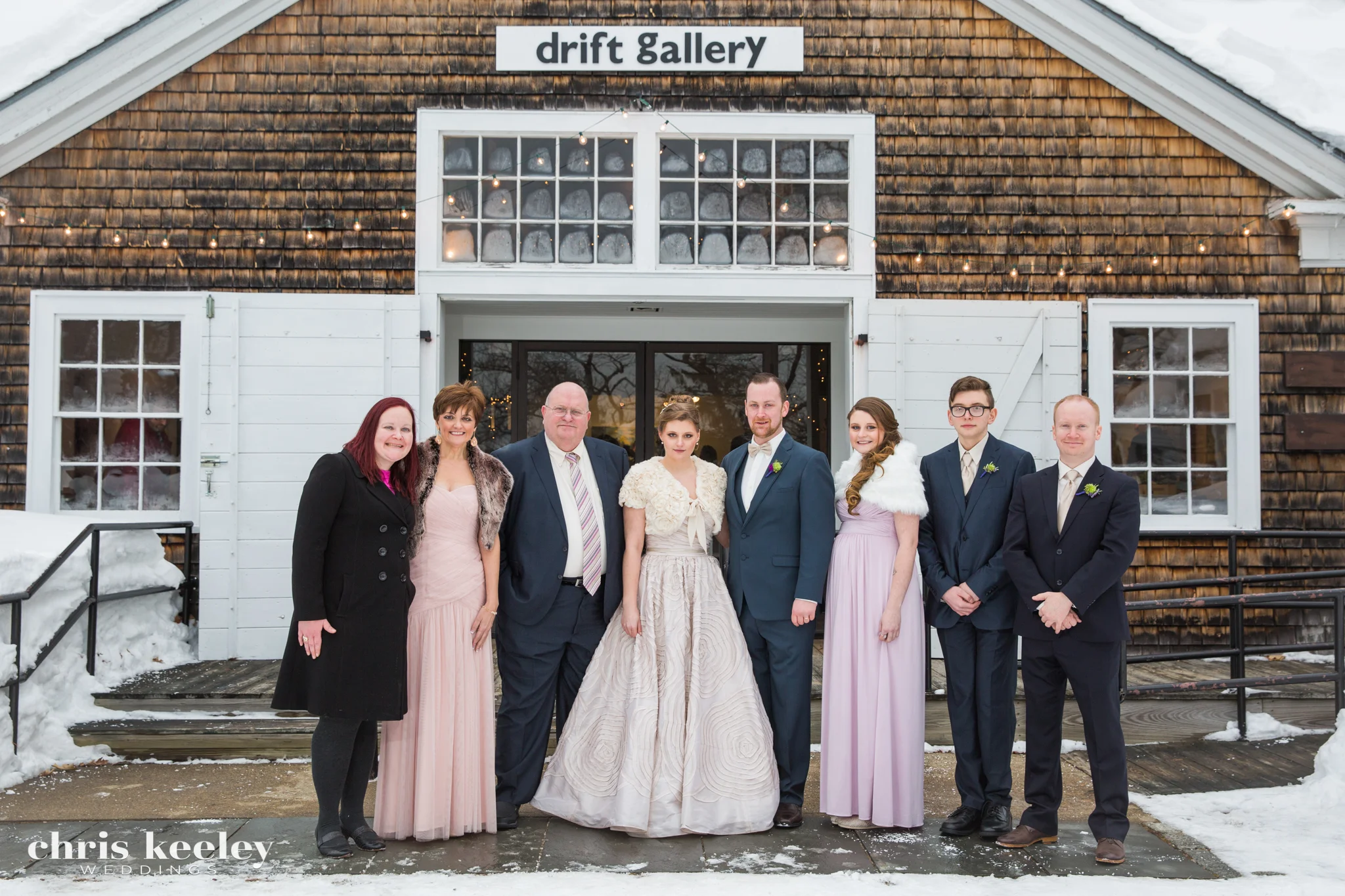 It's smart to photograph the family photos with a backdrop that identifies where your wedding took place. An overcast day, shown here at this winter wedding at the Drift Gallery in Portsmouth, New Hampshire, will allow for the family photos alm…