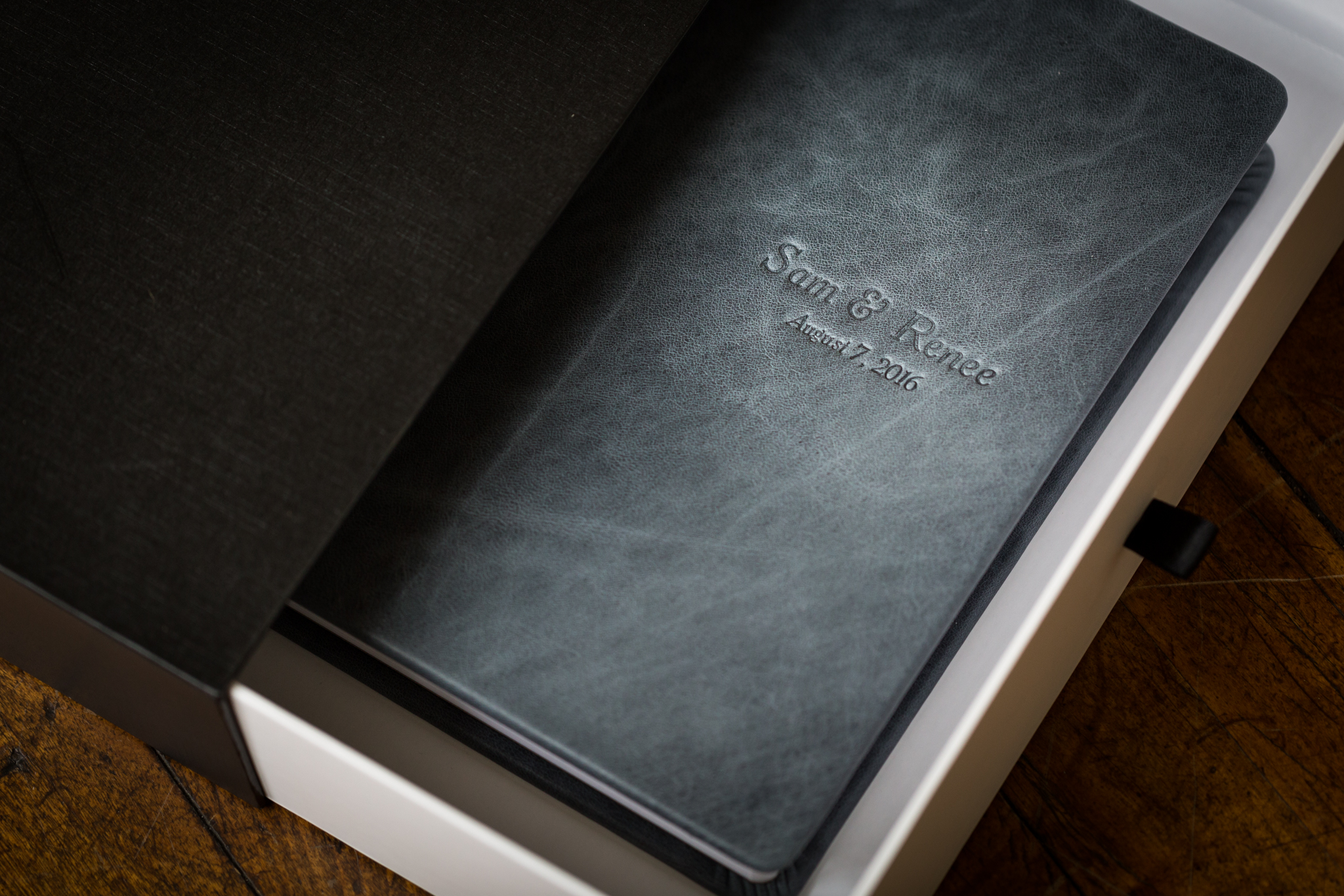 A 10"x10" genuine leather wedding album with the "Rustic Denim" leather and custom debossing with complimentary slide box.