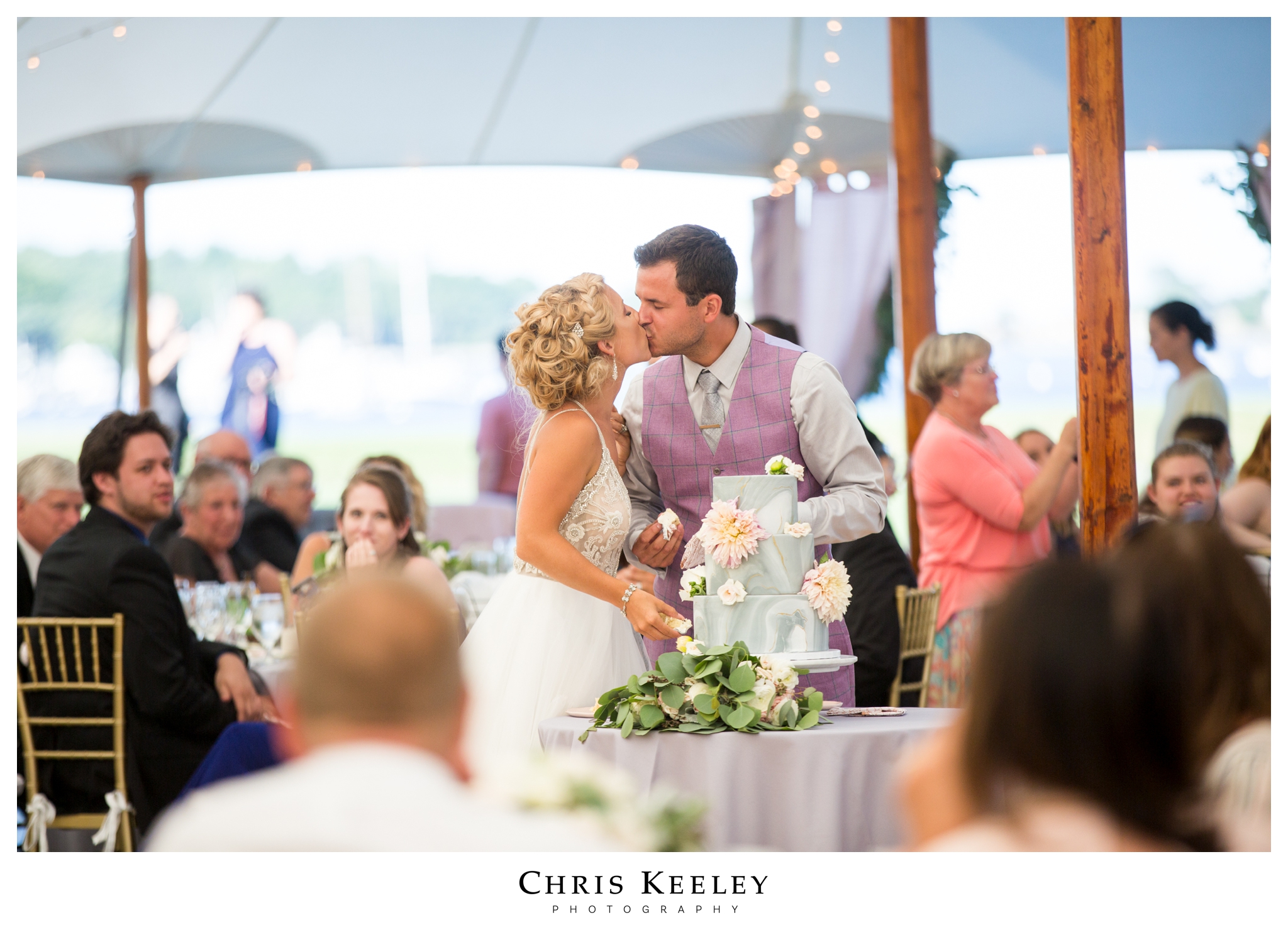 bride-groom-kiss-after-wedding-cake-cut.jpg