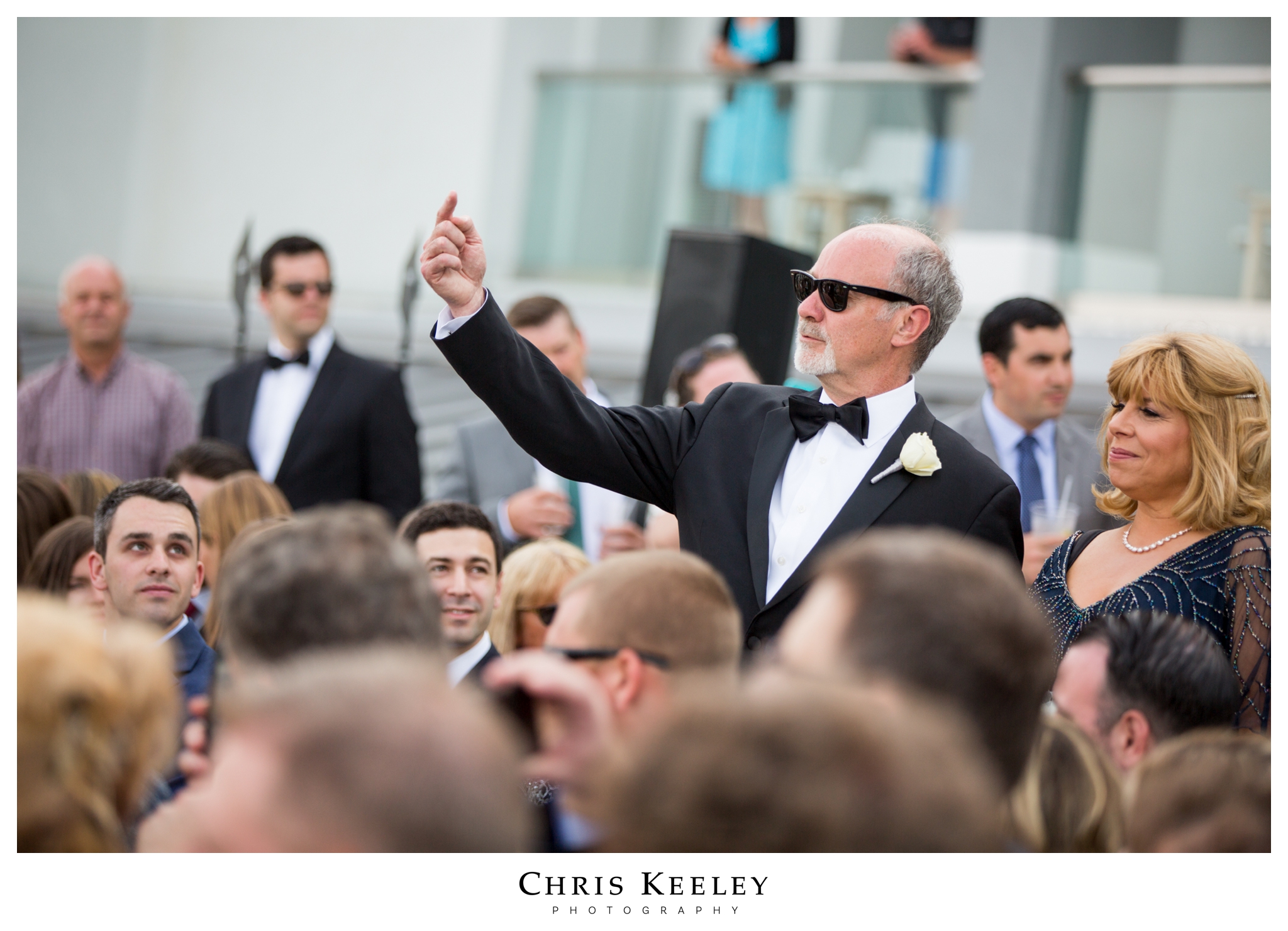 father-pointing-at-son-at-ceremony.jpg