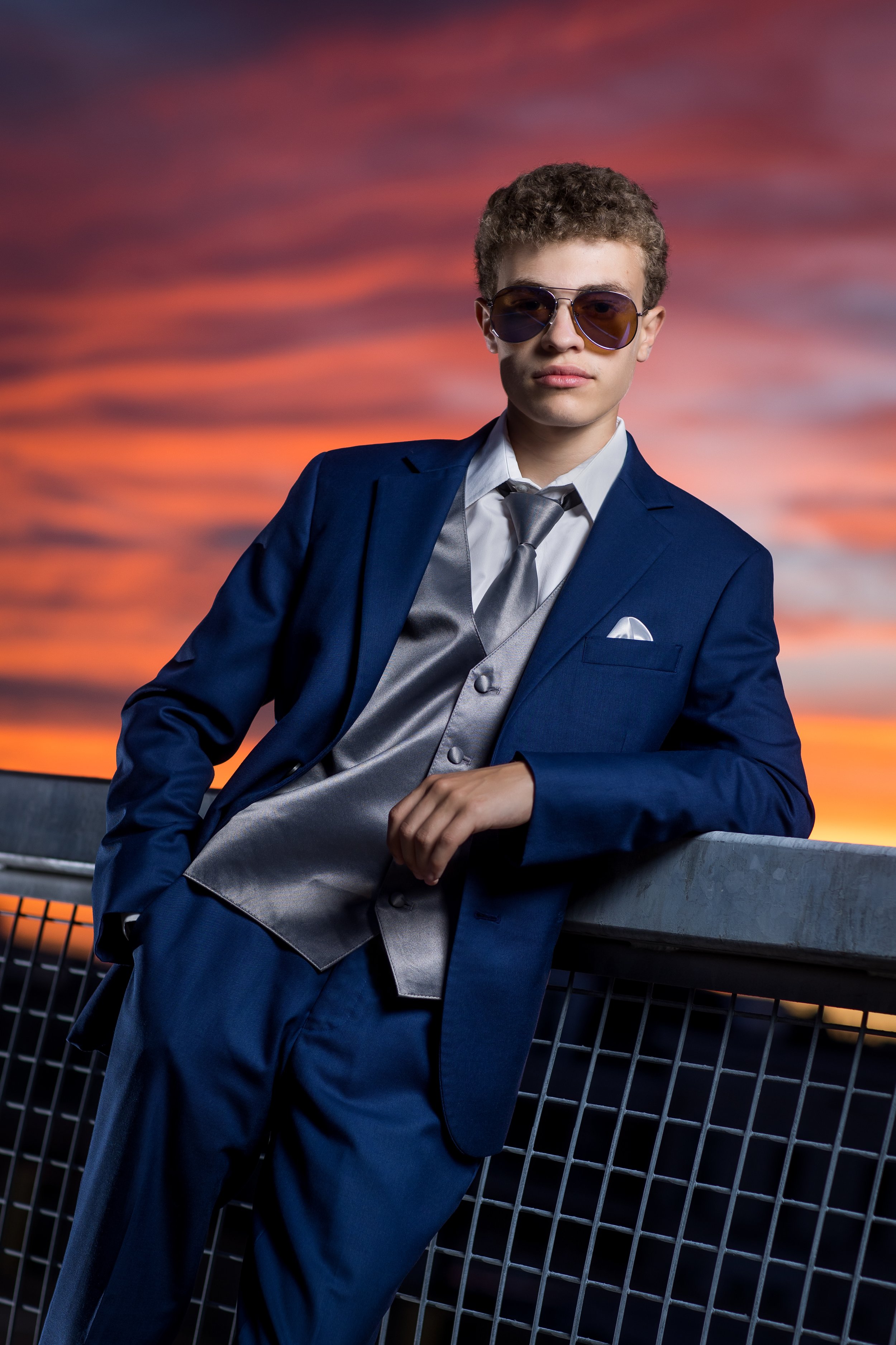 dramatic-lighting-of-senior-portrait-in-cool-suit-at-sunset.jpg