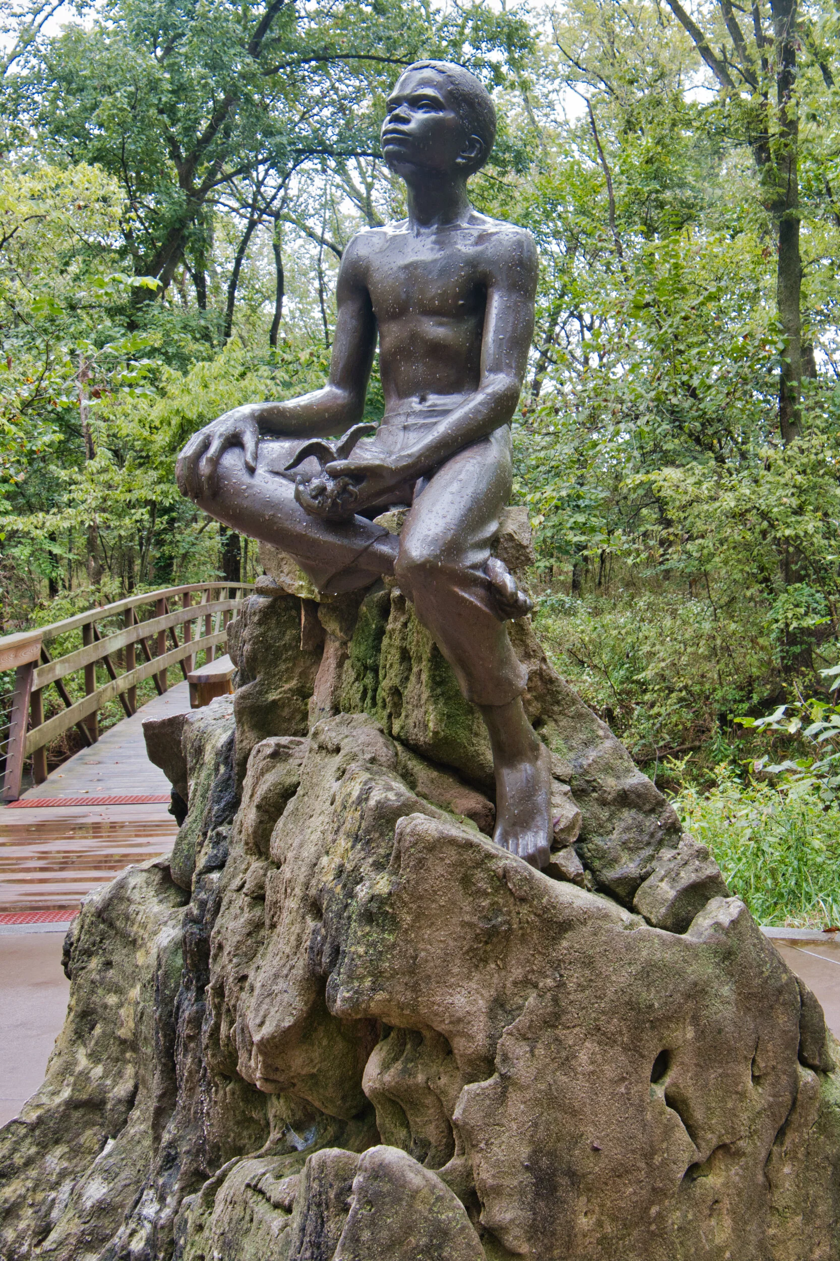 A statue of G. W. Carver as a boy in the woods he loved.