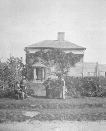 A photo ca. 1888 of the New House with outbuildings visible to the right.