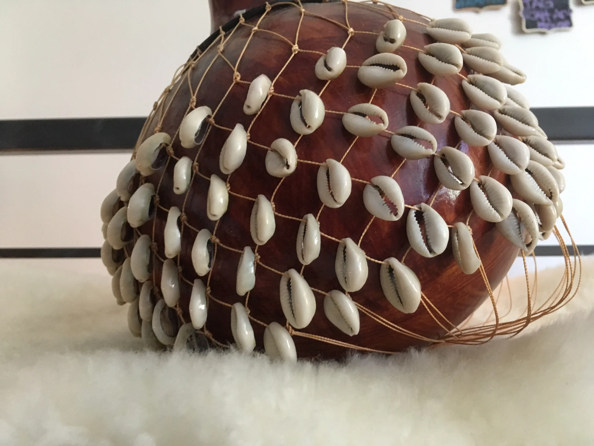 Cowrie Shell shaker in the instrument corner with Tibetan & crystal singing bowls, balaphons, tuning forks, chakra chimes, bells and more. Often used for photo props, video shoots or rehearsals.