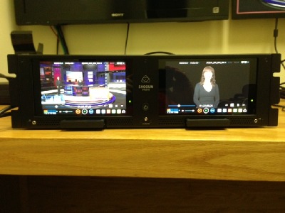 Front-view of the Shogun Studio showing the two 7-inch monitors (1920 by 1200 pixels each) with touchscreen controls, 3U rackmount form, and bottom-mounted caddies for SSDs or 2.5 inch hard drives. And yes, that is Kiki Stockhammer from NewTek. We're also a NewTek TriCaster dealer and used our TriCaster Mini and TriCaster 410 to feed the Shogun Studio HDMI and SDI video sources for this review.