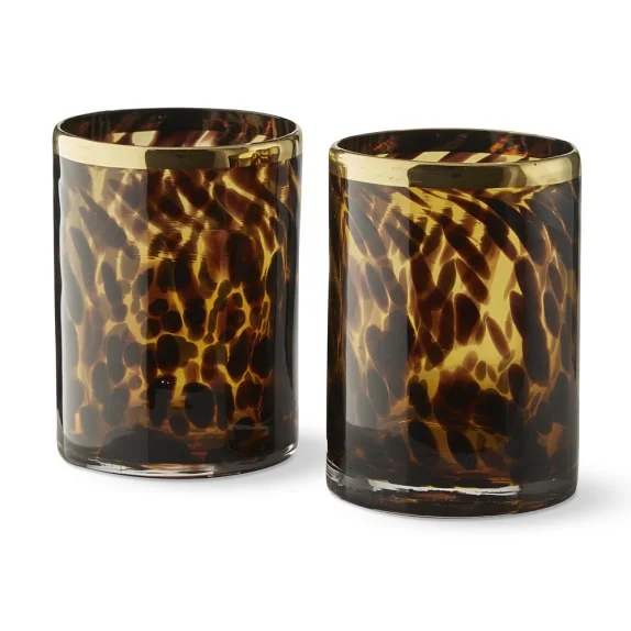 TORTOISE VOTIVE HOLDERS - SET OF 2 - $50 I love votive holders because they can be used practically anywhere throughout the home, the coffee table, mantle, bar/bar cart, table, side table, bed side table, etc. This classic tortoise shell pattern will add a bit of class to any space.