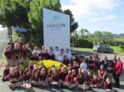 The students around our newly renamed and rebranded sign.