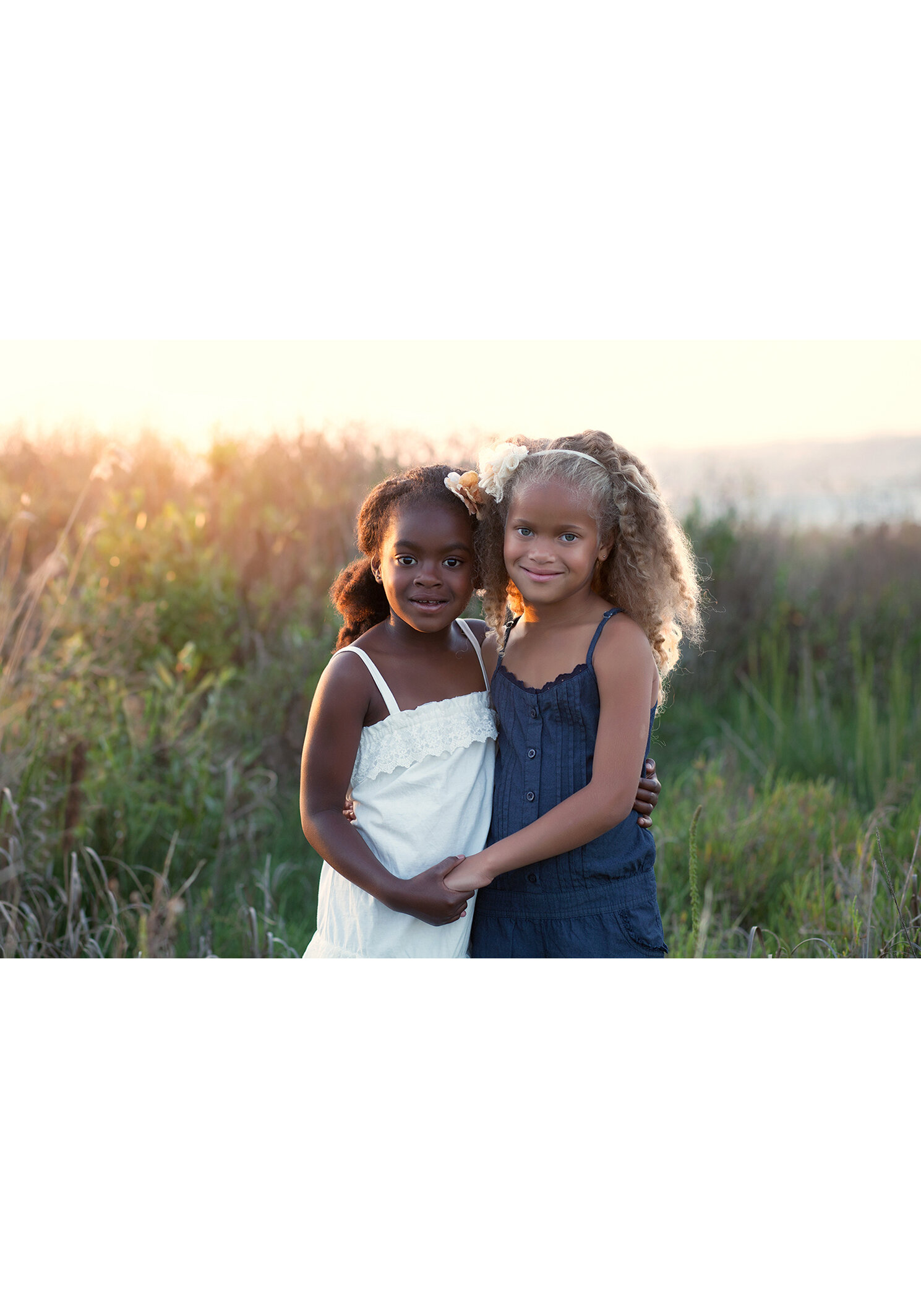 sisters outdoor portrait session waterfront grasses setting sun