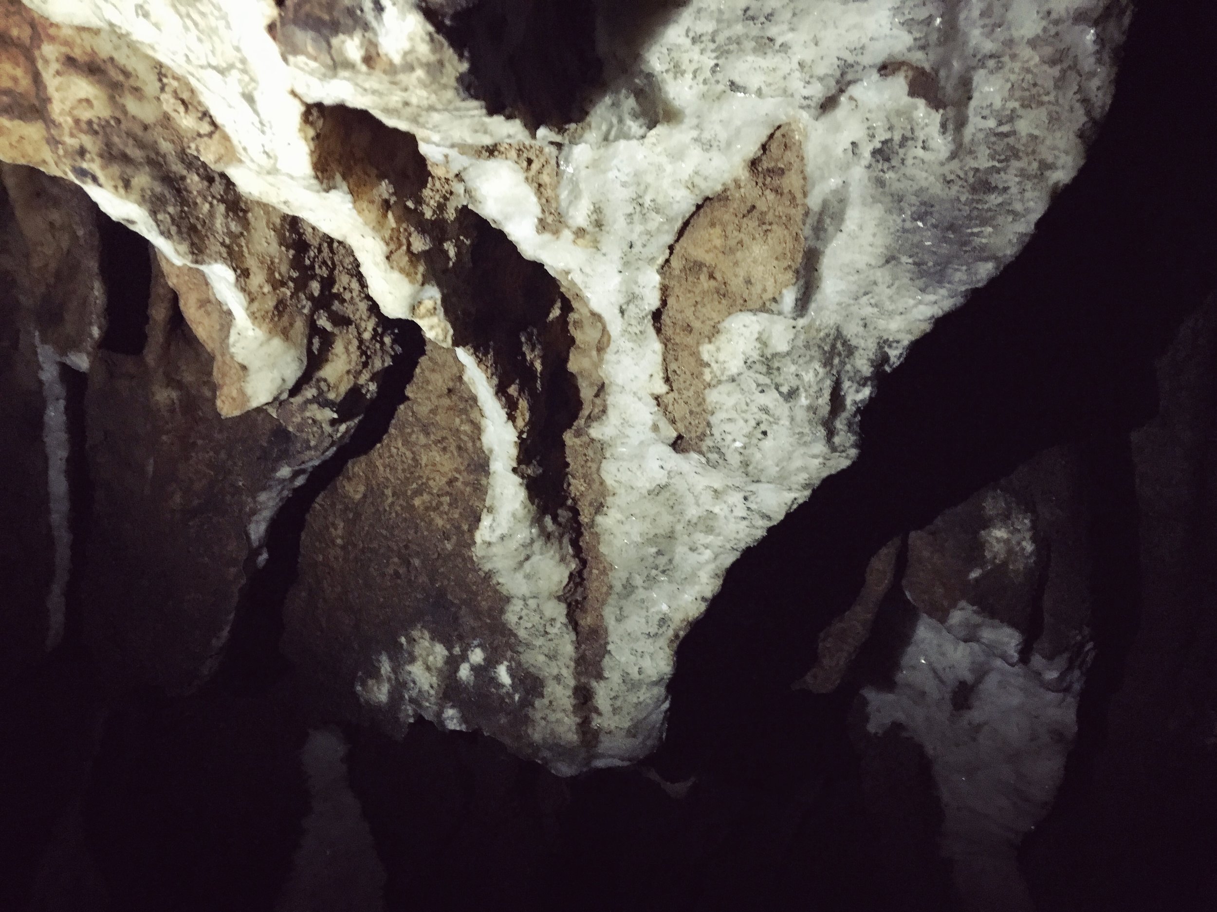 Exploring Tham Kang caves. We found crystal walls and a waterfall deep inside the darkness. These caves used to be a bomb shelter during the Vietnam War era.