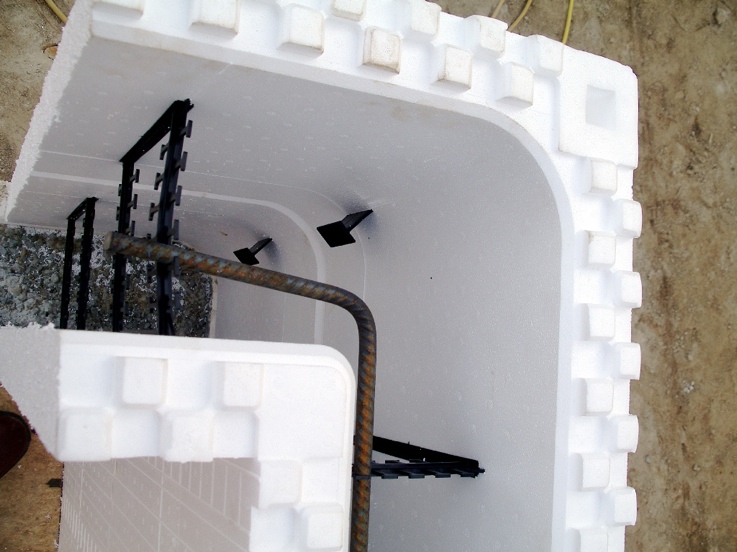 Corner blocks are placed to begin first floor walls