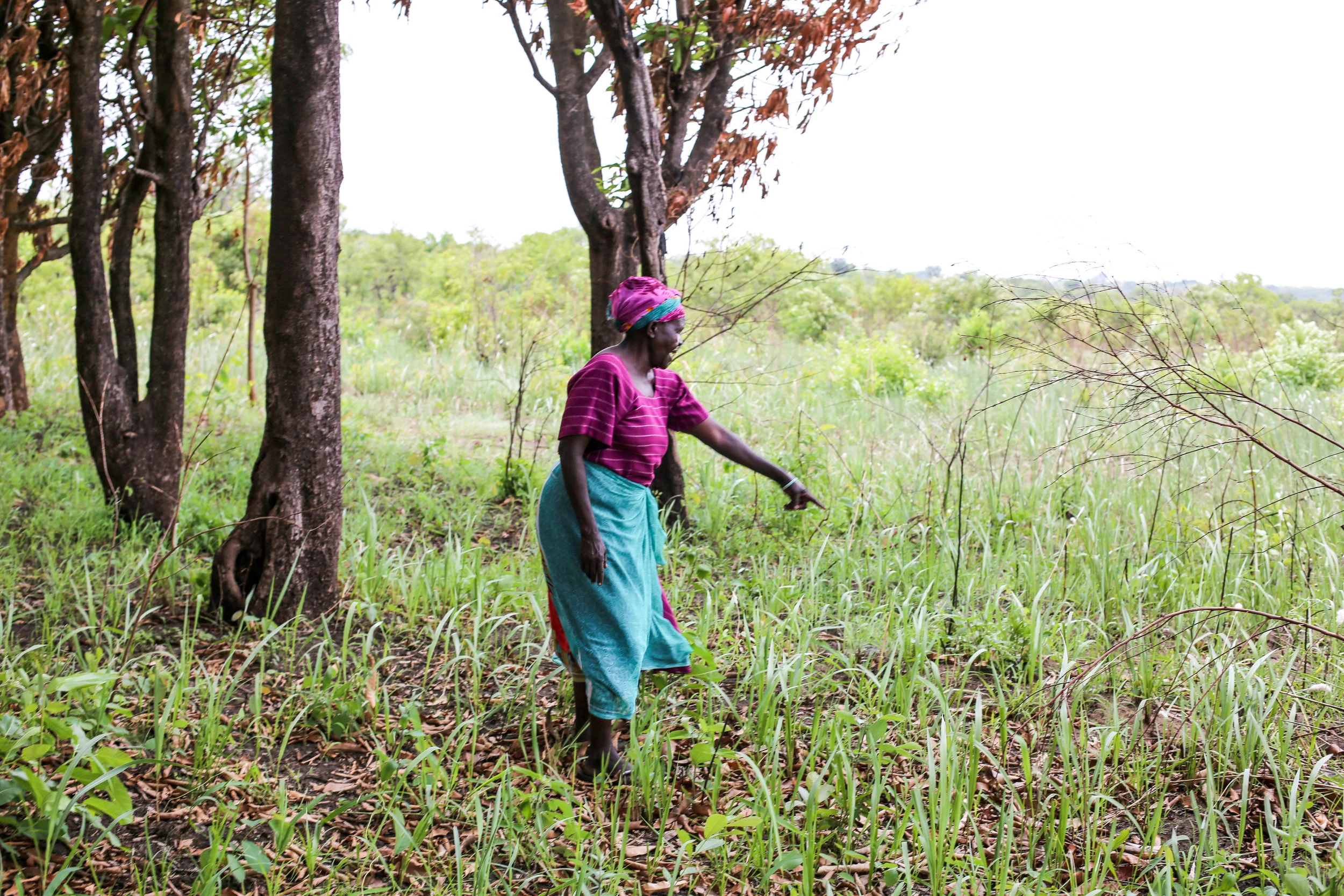 Kelementina's husband had died 12 years prior to her returning to her land. In this photo, she is pointing to his grave on her property.