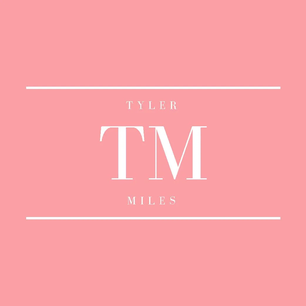 Pink book cover with white text saying "Tyler Miles TM" and decorative lines above and below the text.