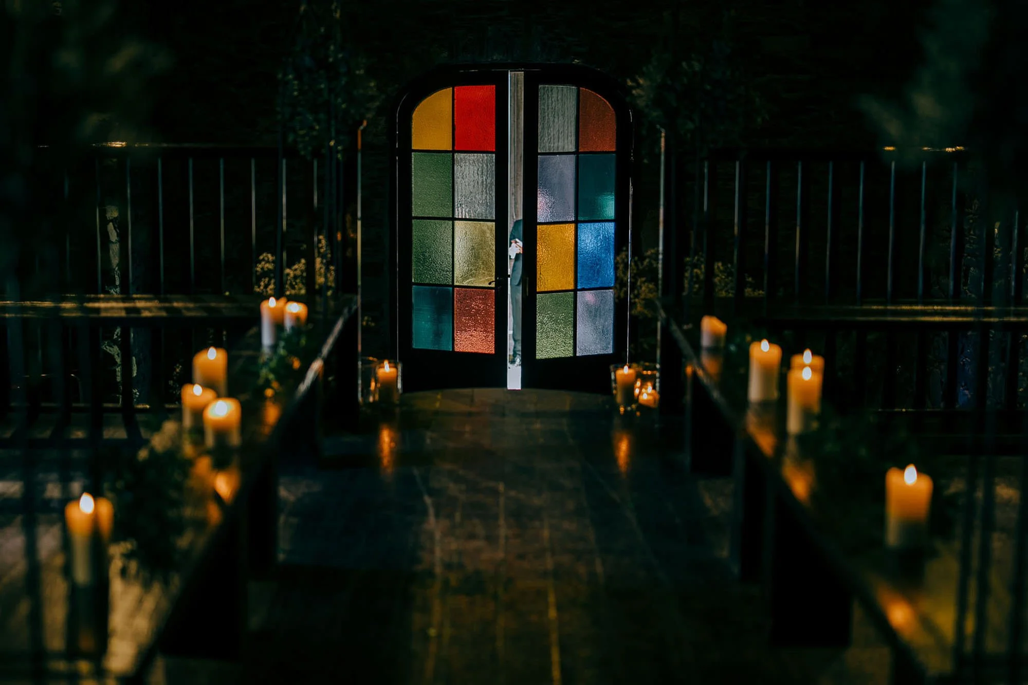 the stained glass door and candles lit in the ceremony room at Ballybeg House