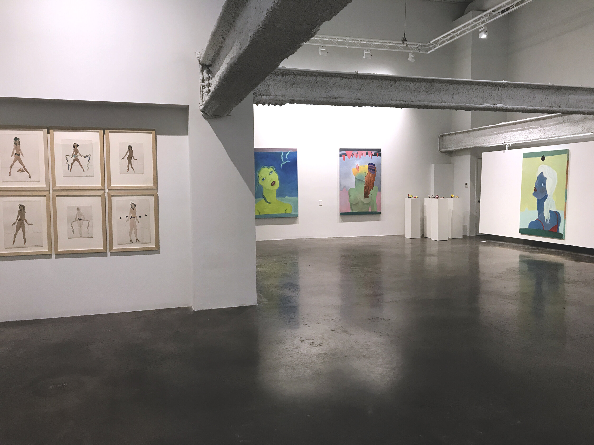  Foreground/left wall:  Womangirls  series (early 70’s)  Ink and watercolor on paper, 16” x 12”  Far wall, left to right:  Sweet Sue Dreaming  (2020),  The Gift of Tongues  (2019),  The Red Dress  (2020)  Oil on canvas, 72” x 48”  