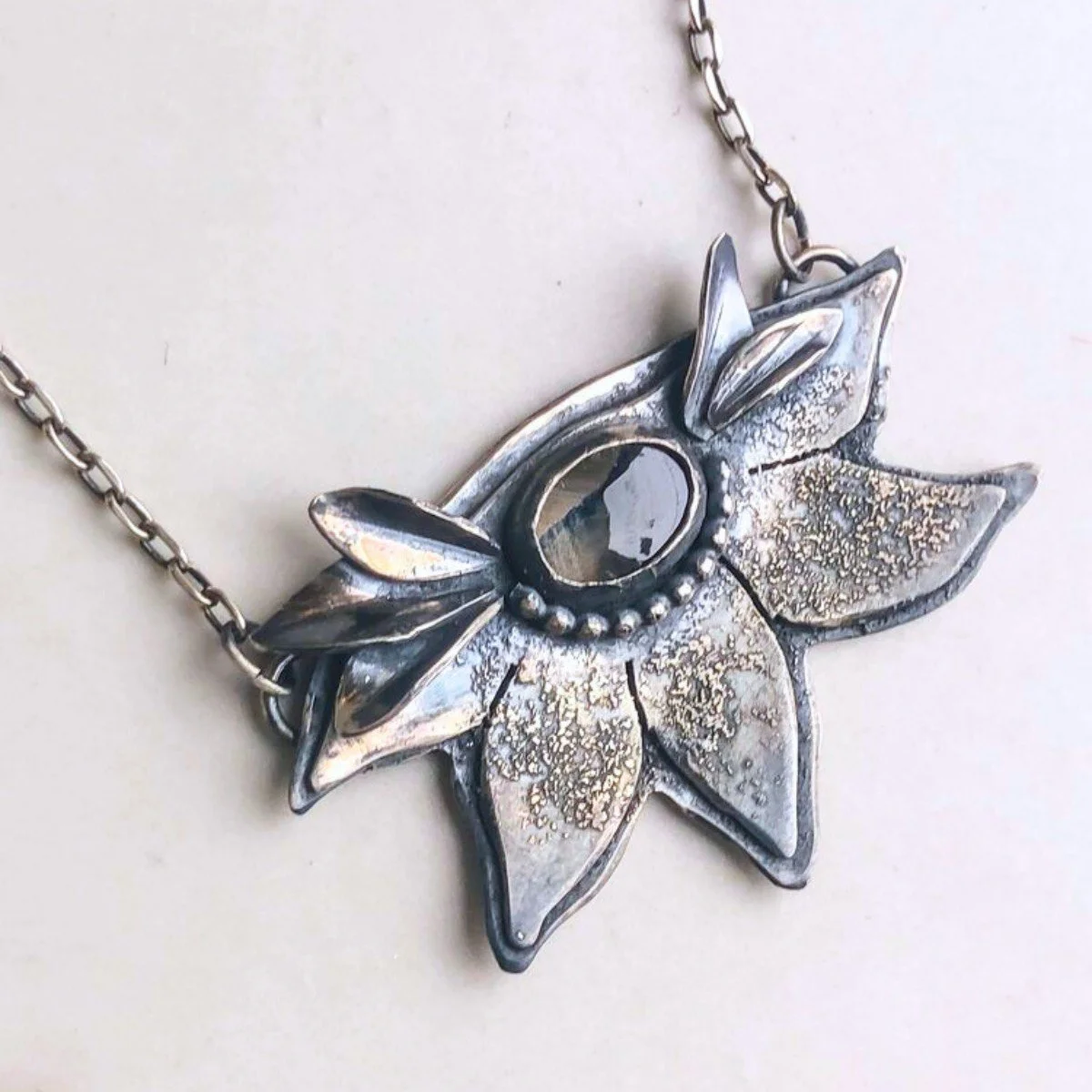 caroline fowler black star sapphire flora necklace.jpg