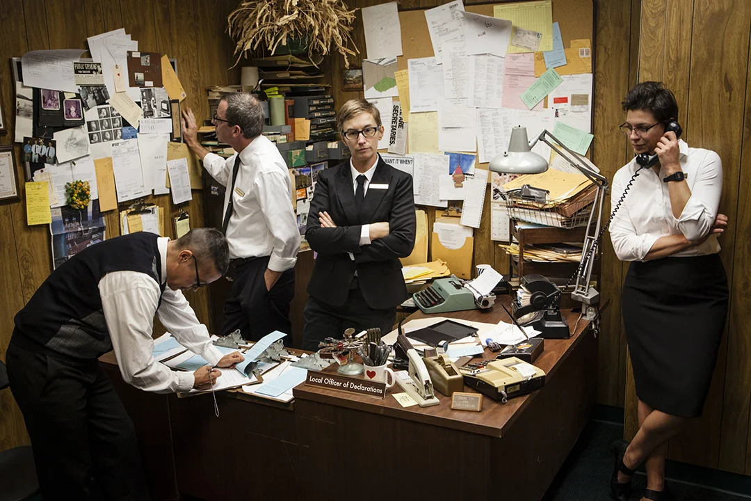 Above is the Durham-based Bureau staff preparing for performances in the Local Office of Declarations. Left to right: Civil Validation Officer Heather Gordon, Complaints Officer Warren Hicks, Local Officer of Declarations Stacey L. Kirby, Identity Officer Harriet Hoover and behind the camera is Documentation Officer Alex Maness.