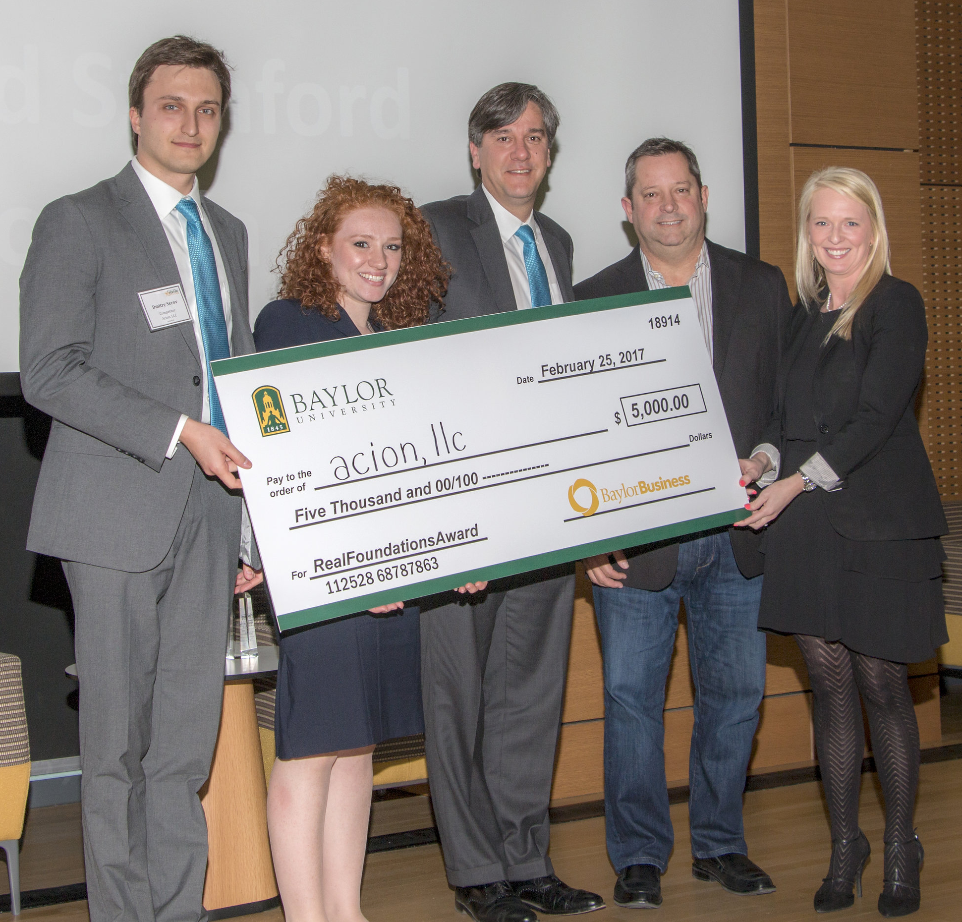 Dmitry Serov, Paige Harrison, and Chad Keinanen of Acion, LLC receiving the RealFoundations Award from David Stanford and Lauren Stokes.