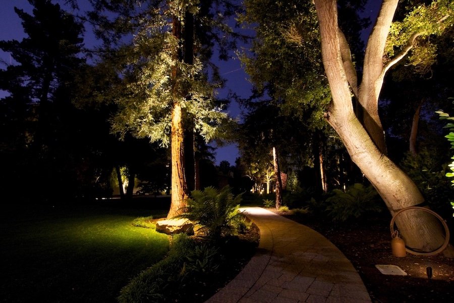 Exterior lighting installed at a Hillsborough home to light up paving stone walkways.