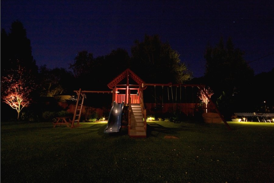 Accent lighting on backyard swing set and plants installed in Atherton, CA.