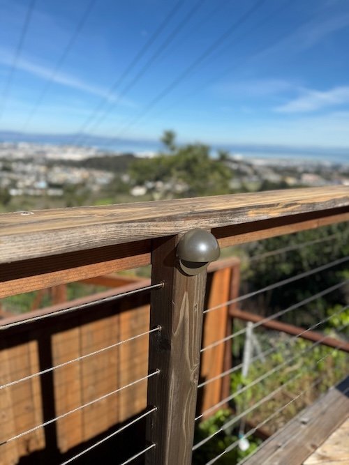 Post light installed on wooden deck railing in San Jose, CA home for safety and elegance.