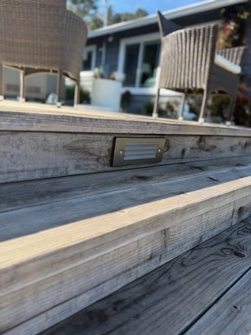 Step lights installed for entry way lighting on stairs for safety and curb appeal.