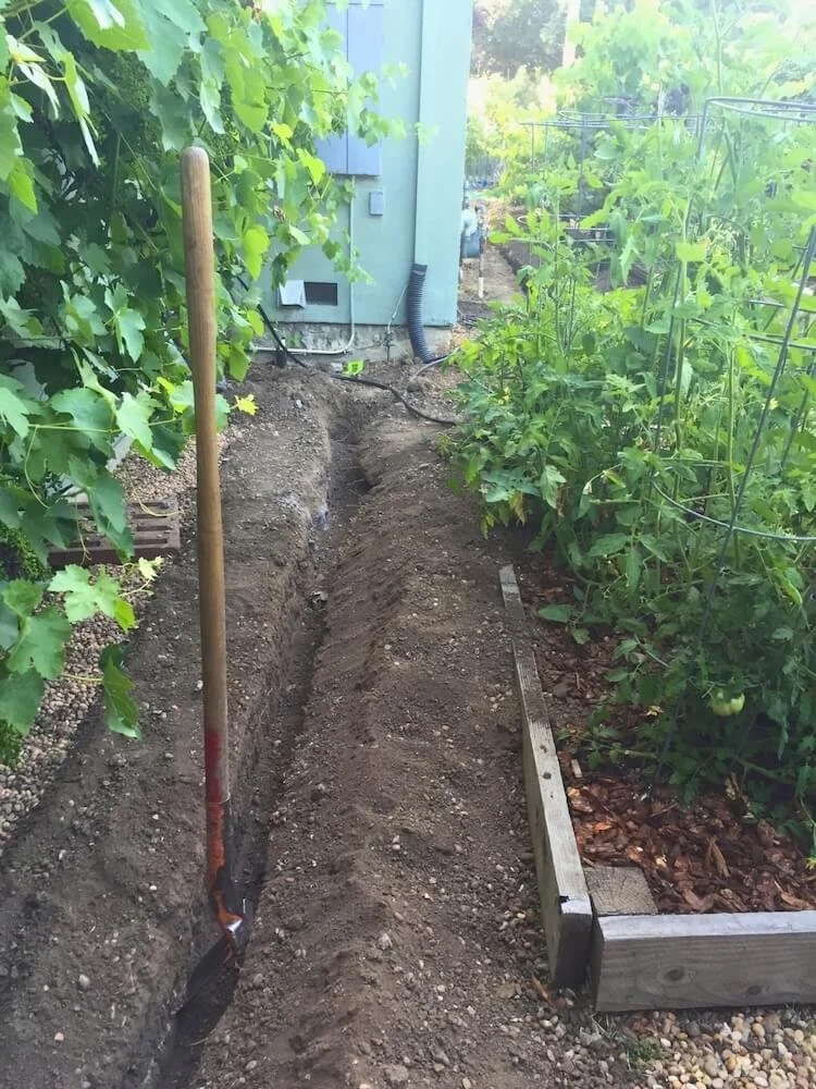 Trench dug through garden to allow access for a water mainline replacement for Cupertino home.