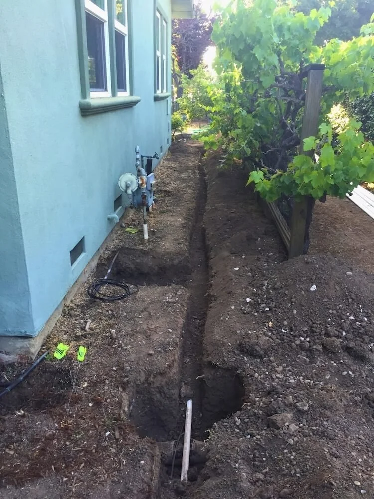 Trenches and access points allowing repair for water mainline in Millbrae.