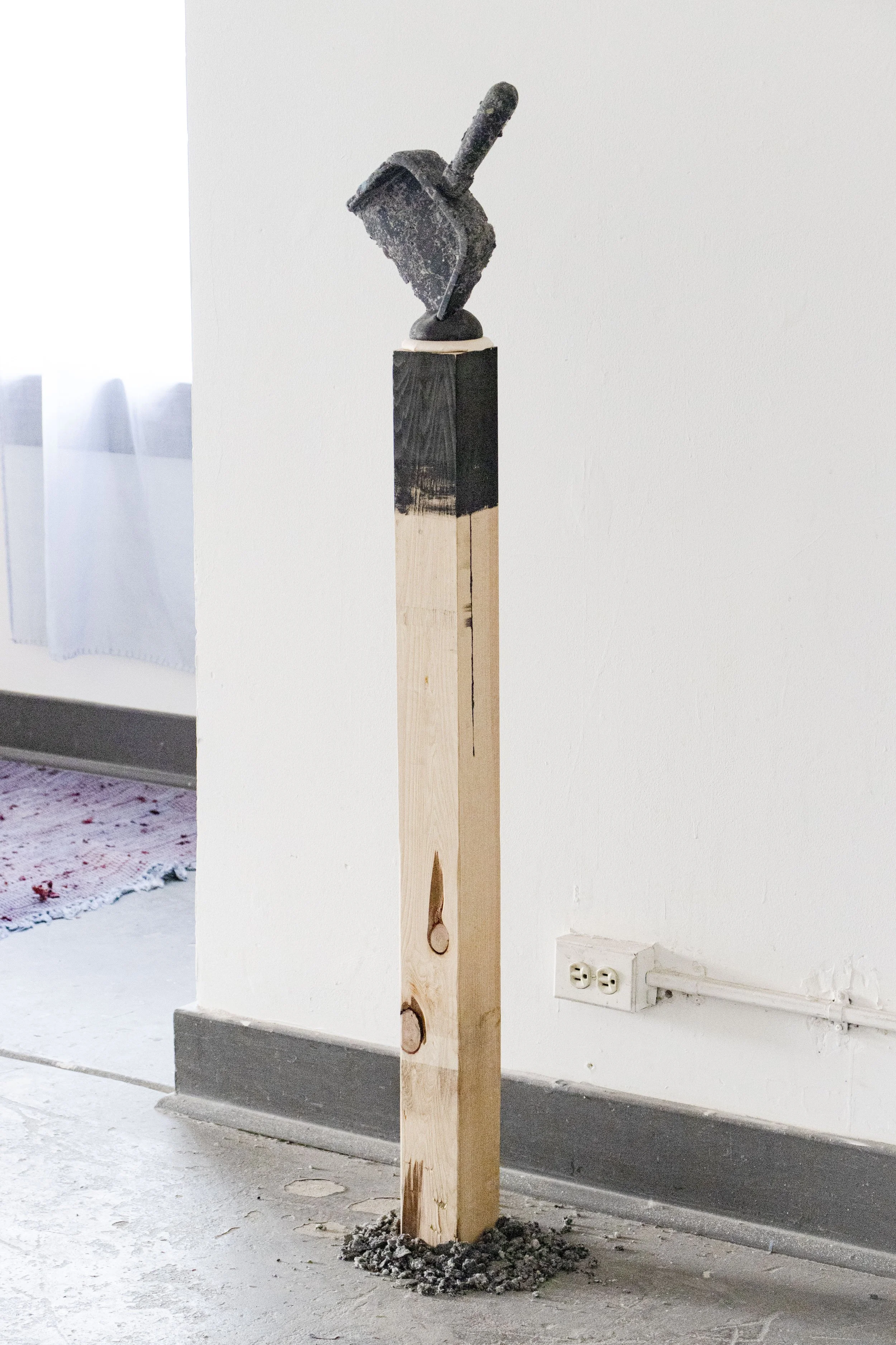  Dust at Dusk, 2026,   dryer lint, cast stone, fabric, wood,   8” x 8” x 54”  photo by Alissa Touranachun 
