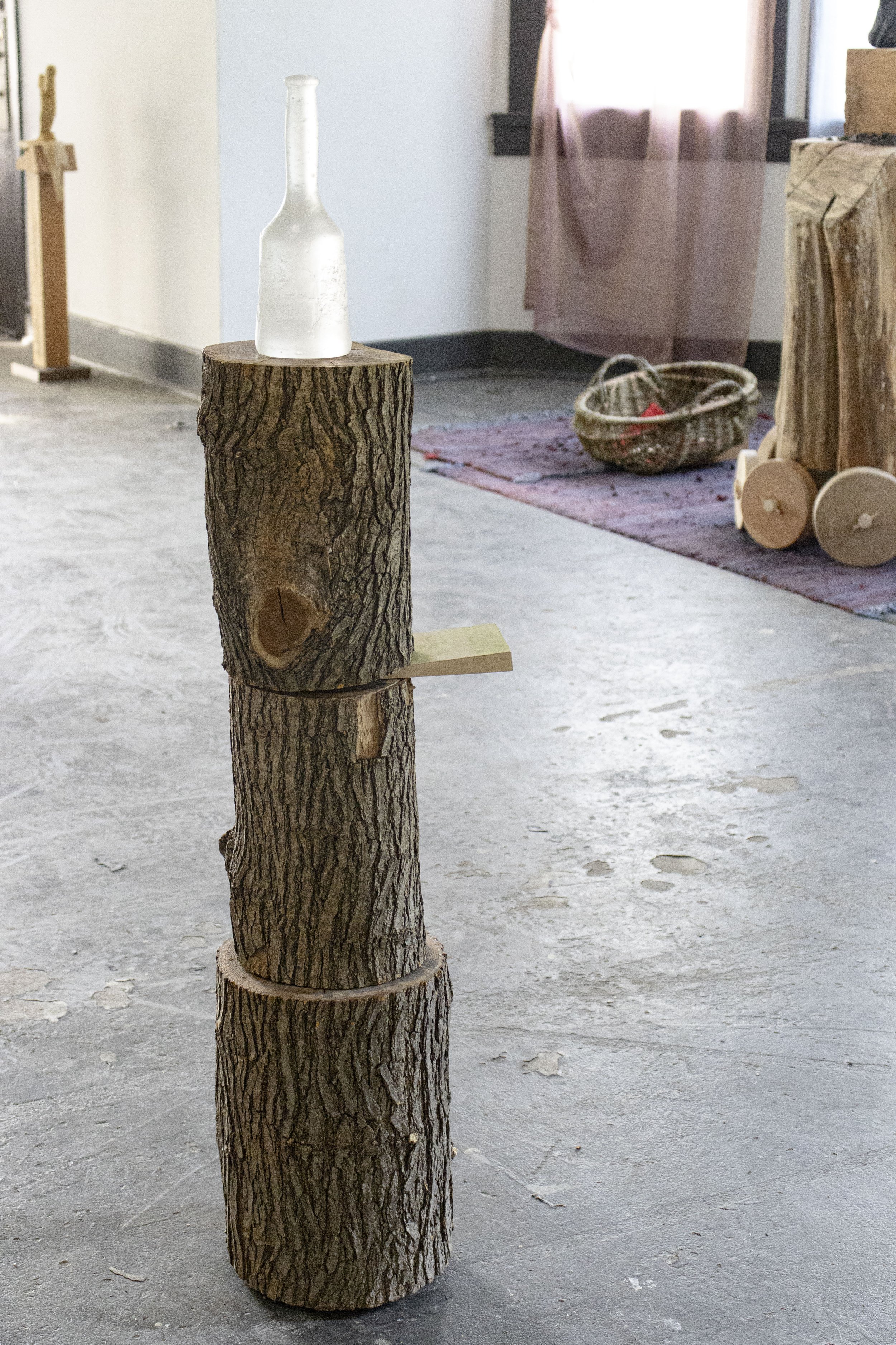  The Tool, 2026,   cast glass, wood,   11” x 10” x 49”  photo by Alissa Touranachun 