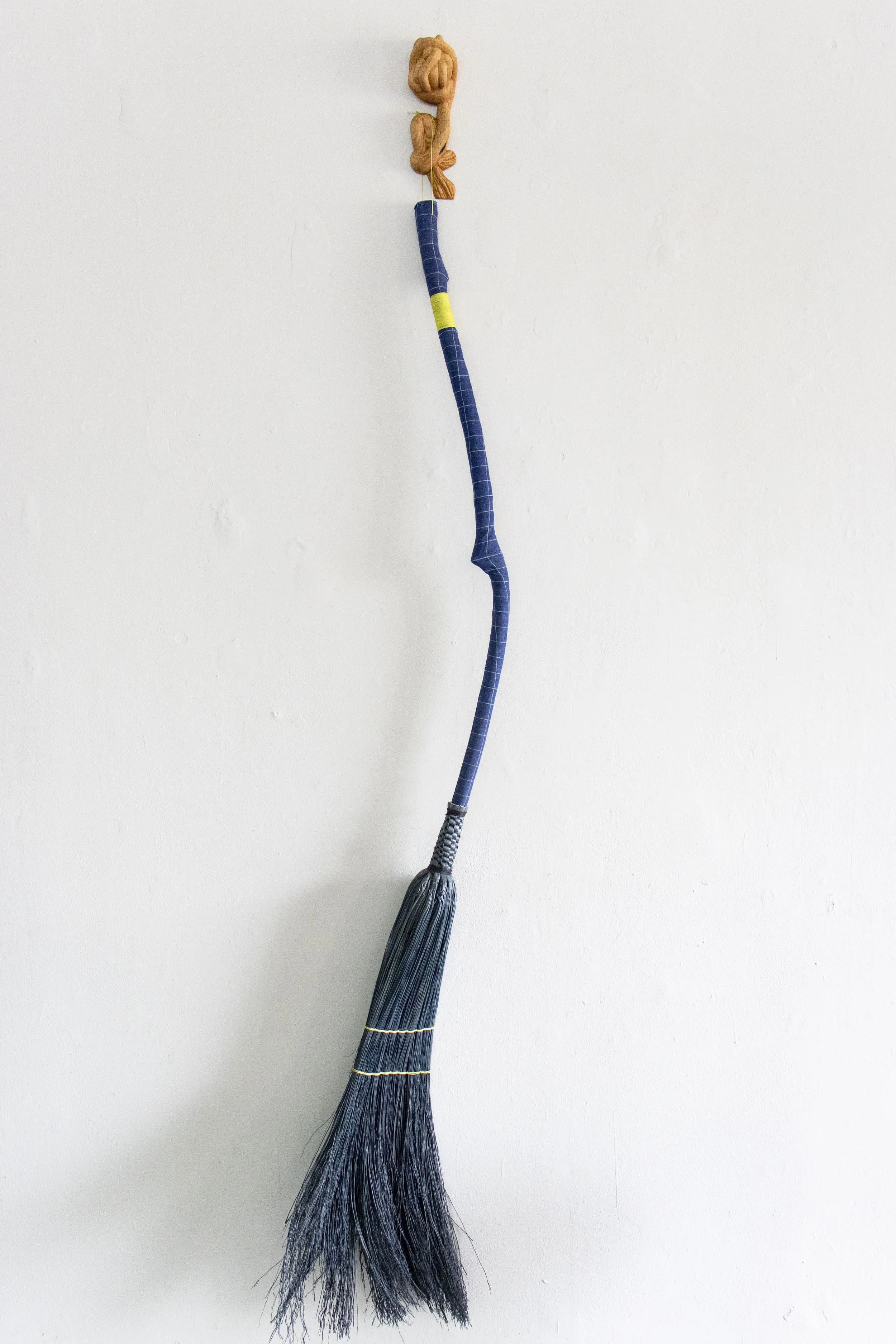  The Vehicle, 2026,   broomcorn, fabric, stick, oak,   14” x 5” x 80”  photo by Alissa Touranachun 