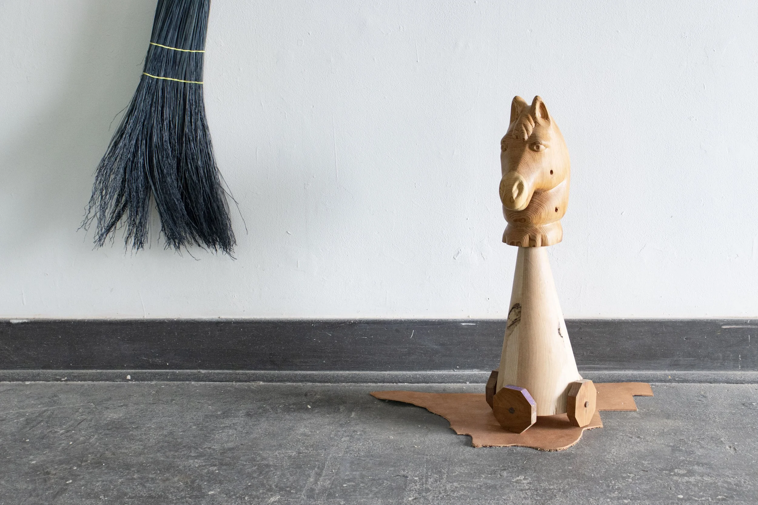  Guardian, 2026,   wood, colored pencil, leather,   28” x 17” x 28”  photo by Alissa Touranachun 