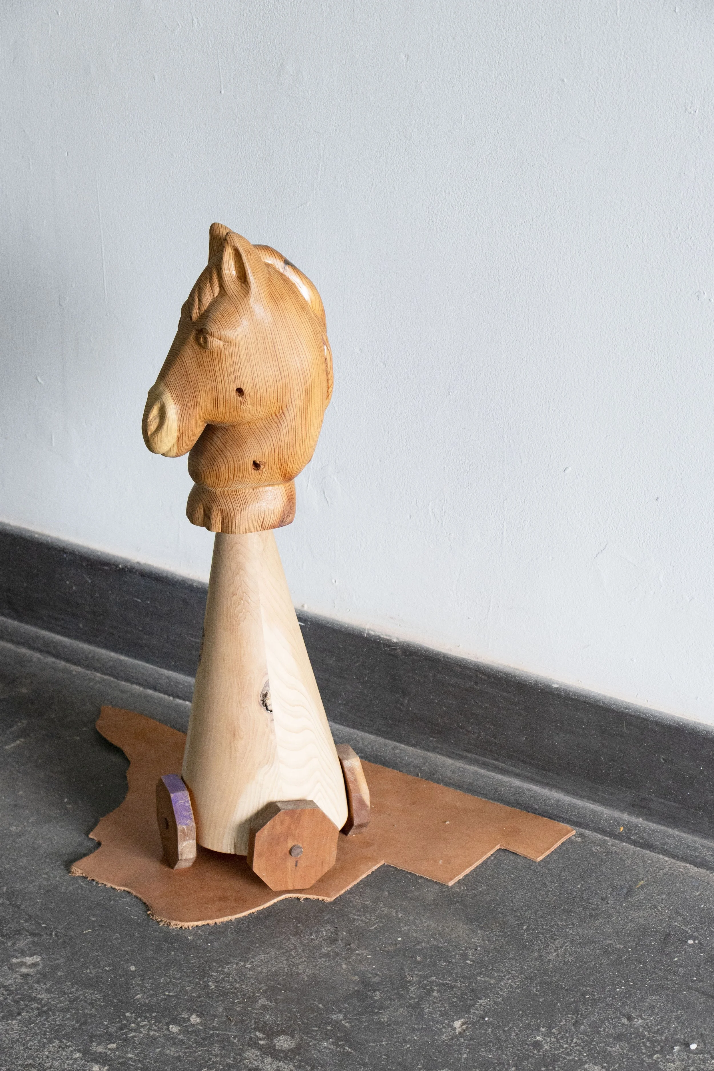  Guardian, 2026,   wood, colored pencil, leather,   28” x 17” x 28”  photo by Alissa Touranachun 